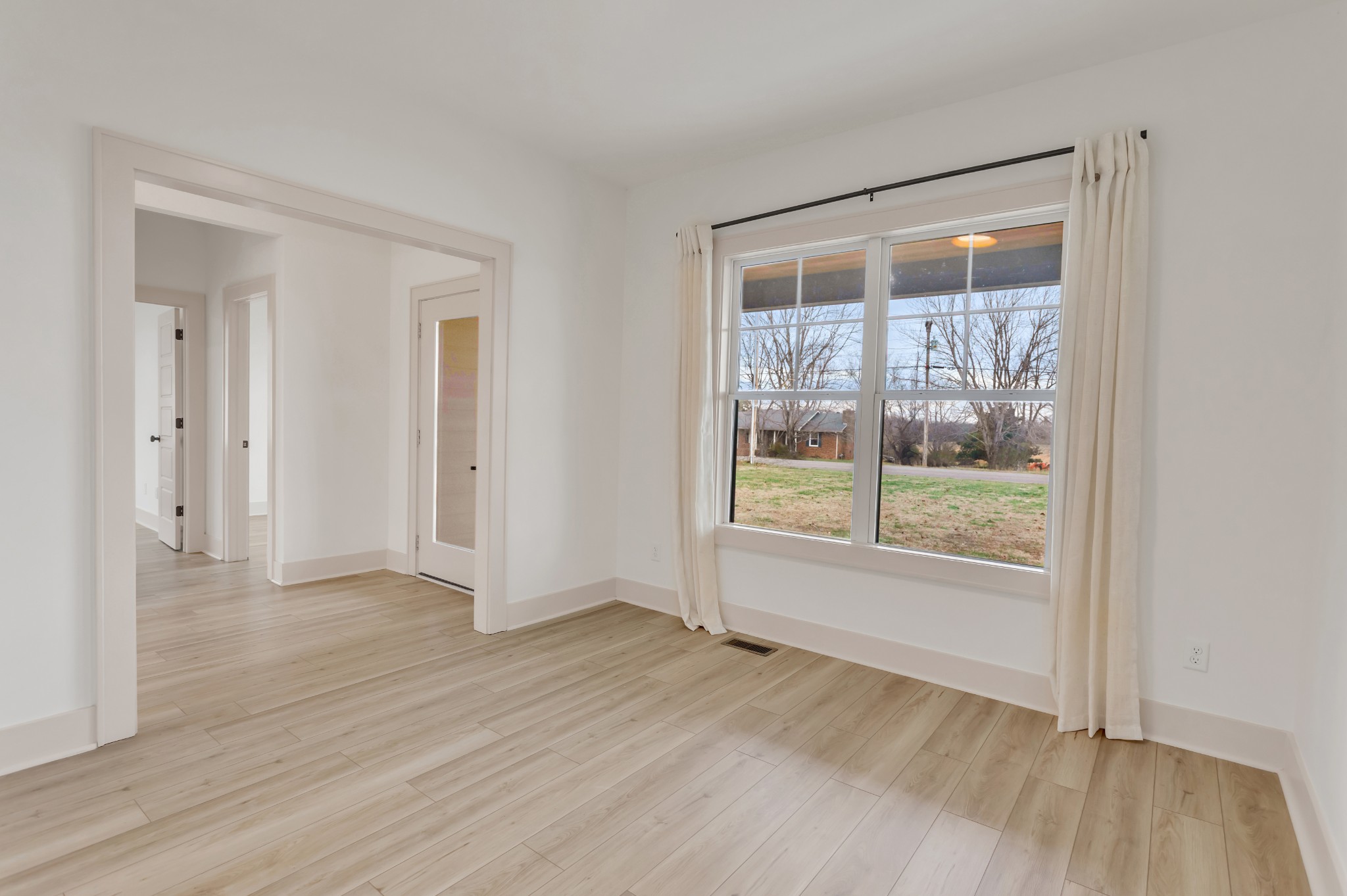 2140 Abiff Road Burns, TN 37029 - Photo 20 of 40 a view of an empty room with wooden floor and a window