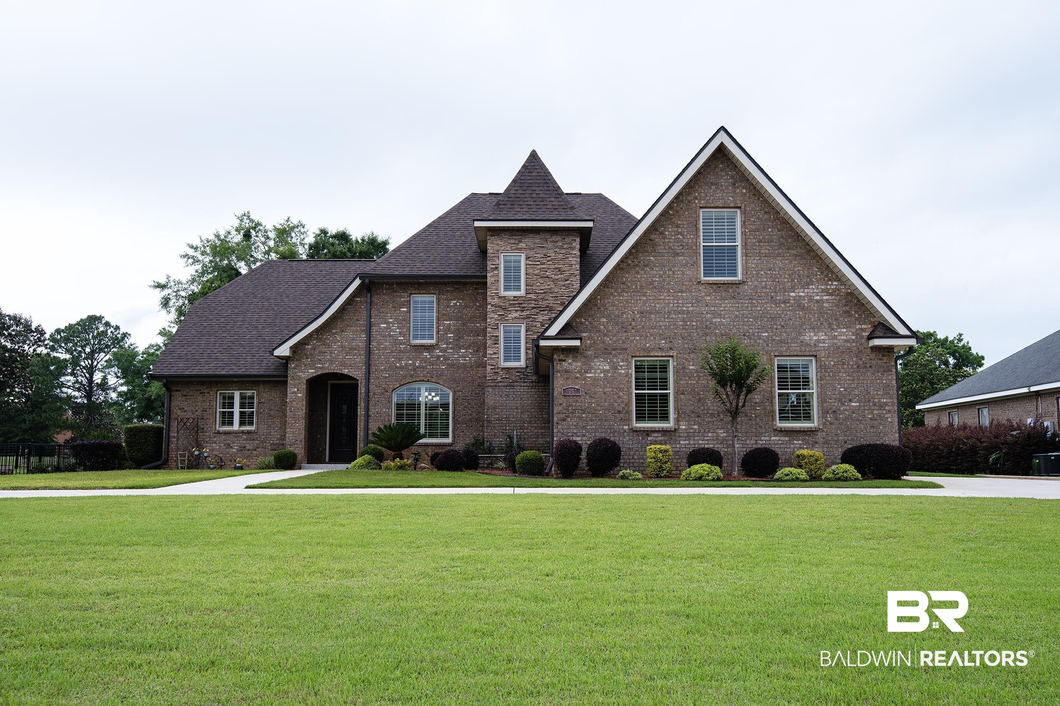 9357 Lakeview Drive Foley, AL 36535 - Photo 1 of 68 Traditional brick exterior featuring a prominent gabled roofline and architectural turret detail