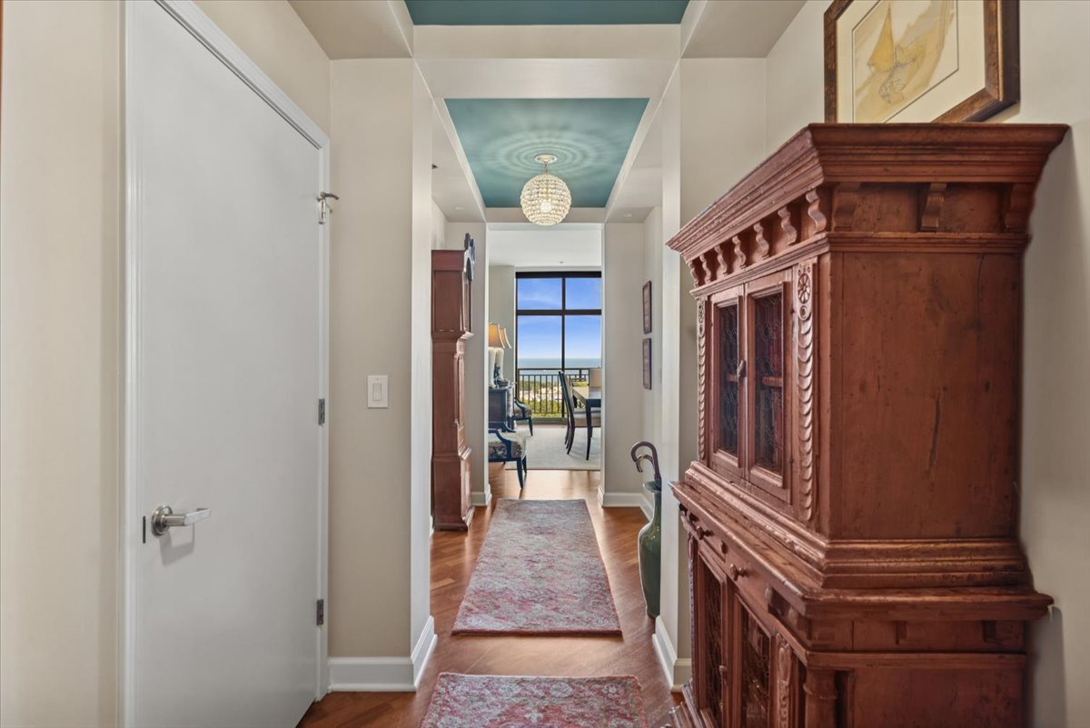 a view of a hallway with wooden floor and staircase