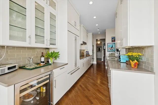 a kitchen with stainless steel appliances a sink a stove and cabinets