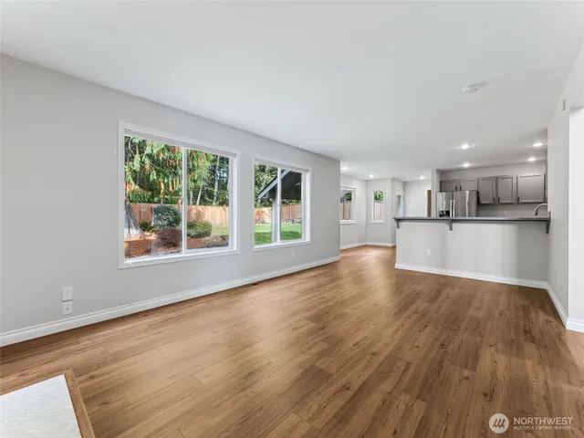 a kitchen with stainless steel appliances granite countertop a refrigerator sink and microwave