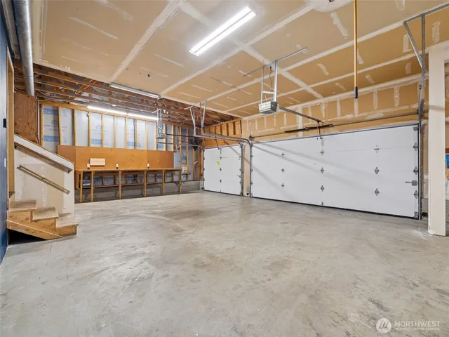 an empty room with a ceiling fan and a window