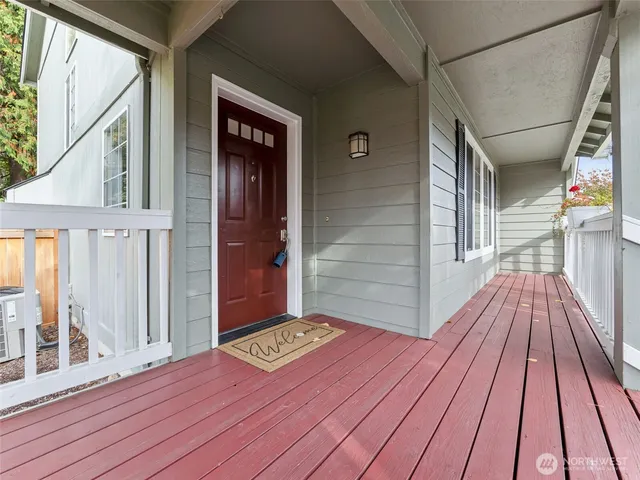 an empty room with wooden floor and fireplace