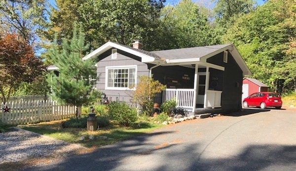 211 Westhampton Road Northampton, MA 01062 - Photo 1 of 21 a view of a house that has a small yard and large trees