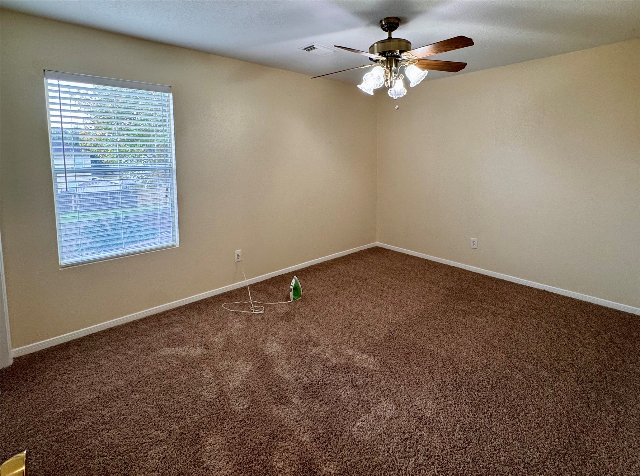 12206 Beacon Tree Court Humble, TX 77346 - Photo 18 of 25 an empty room with windows and fan