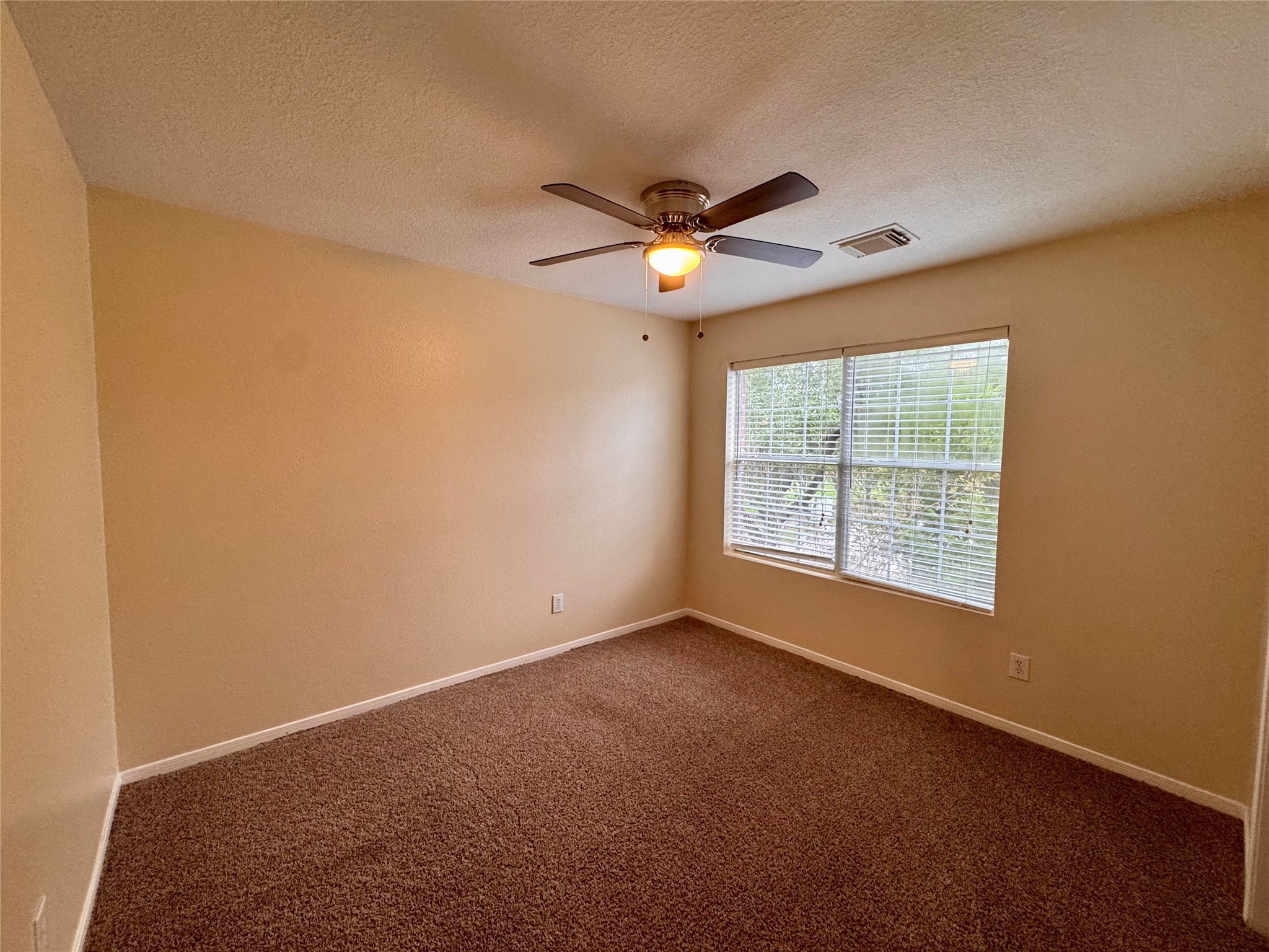 12206 Beacon Tree Court Humble, TX 77346 - Photo 19 of 25 a view of an empty room with a window