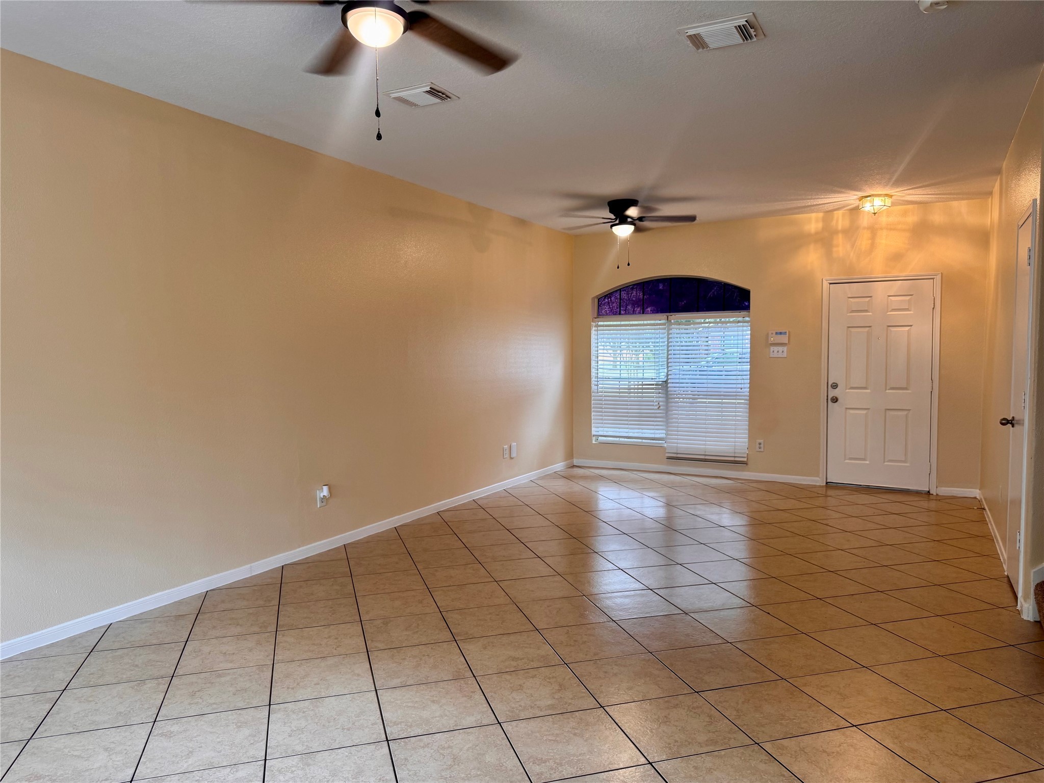 12206 Beacon Tree Court Humble, TX 77346 - Photo 2 of 25 wooden floor in an empty room with a window