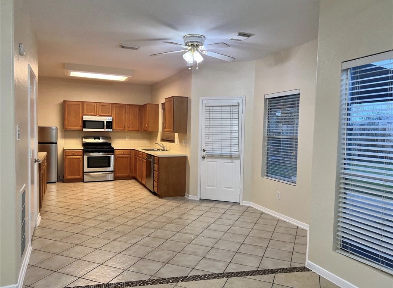 12206 Beacon Tree Court Humble, TX 77346 - Photo 4 of 25 a kitchen with stainless steel appliances a refrigerator and a stove top oven