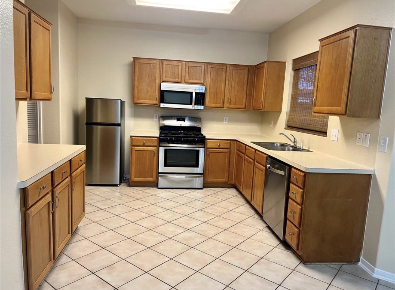 12206 Beacon Tree Court Humble, TX 77346 - Photo 6 of 25 a kitchen with stainless steel appliances granite countertop a refrigerator stove and sink