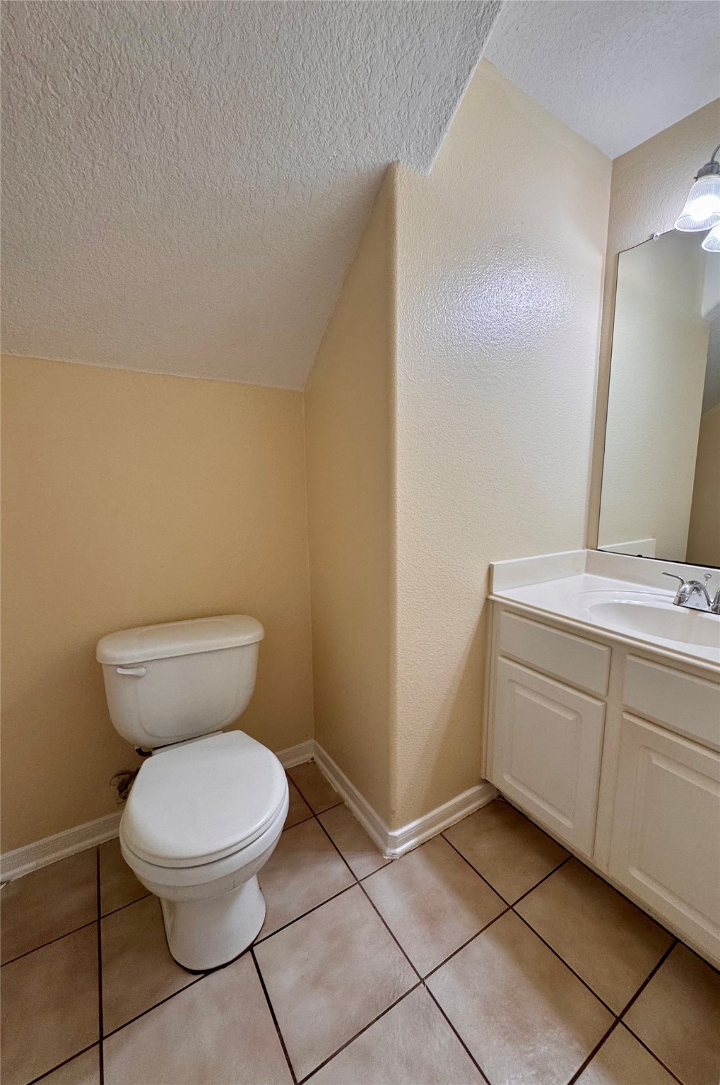 12206 Beacon Tree Court Humble, TX 77346 - Photo 10 of 25 a bathroom with a toilet sink and mirror