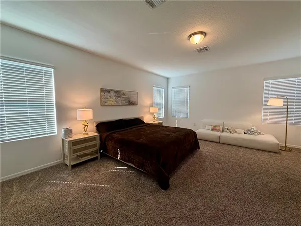 a bedroom with a bed and window