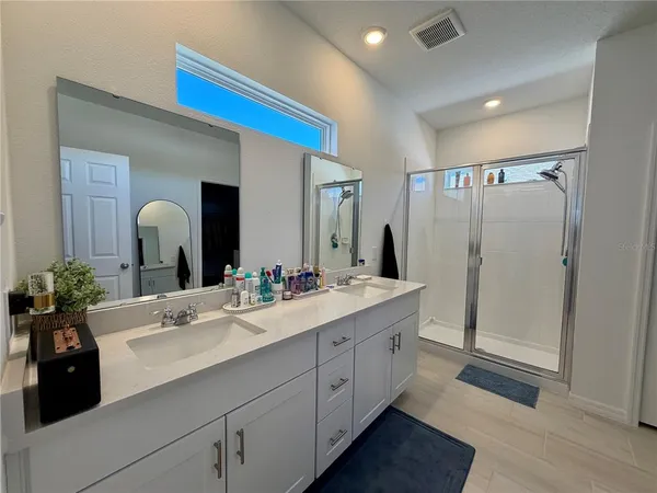 a en suite bathroom with double sink and a mirror