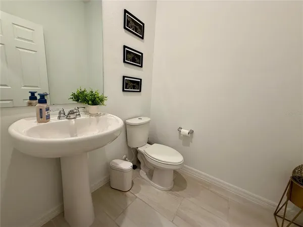 a bathroom with a sink toilet and mirror