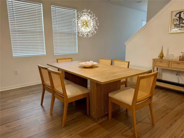 a dining room with furniture and wooden floor