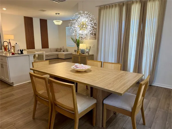 a dining table with chairs and wooden floor
