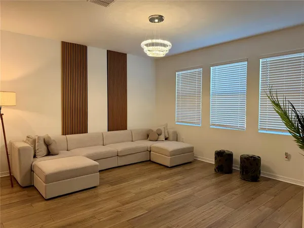 a living room with furniture and a large window