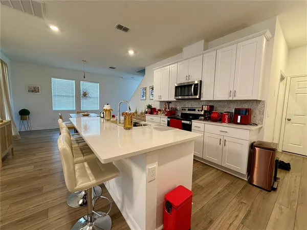 a kitchen with a sink a microwave and cabinets