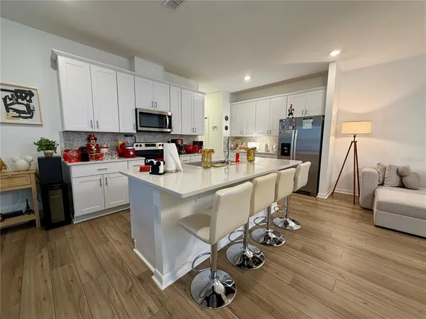 a kitchen with a sink appliances and cabinets