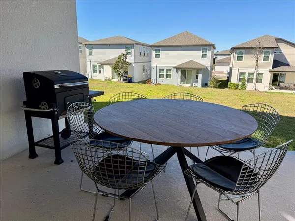 a view of a chairs and table in the patio