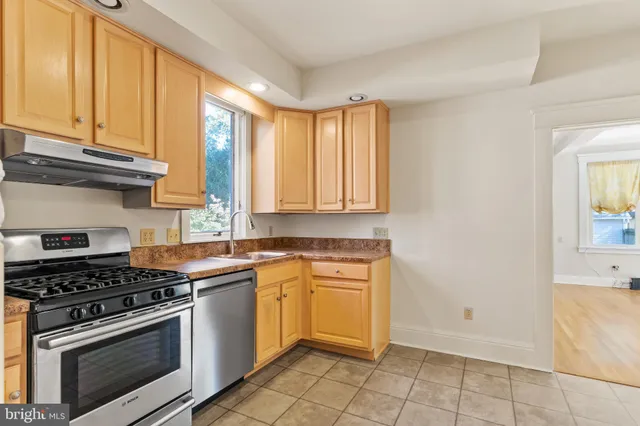 a kitchen with a stove a sink and cabinets