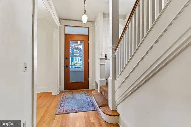 a view of staircase with wooden floor and fan