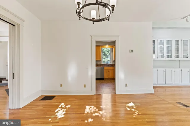 a view of a room with wooden floor and a rug