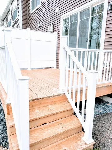 a view of a house with backyard and deck