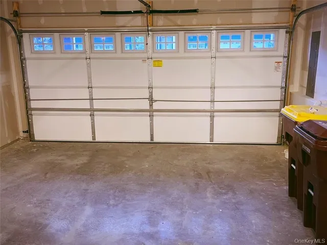 a view of a brick house with a small yard and a large window