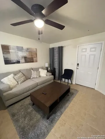 a living room with furniture and a chandelier