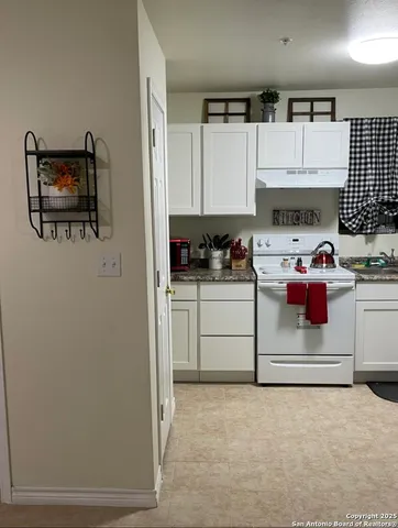 a kitchen with stainless steel appliances a stove a sink and a refrigerator