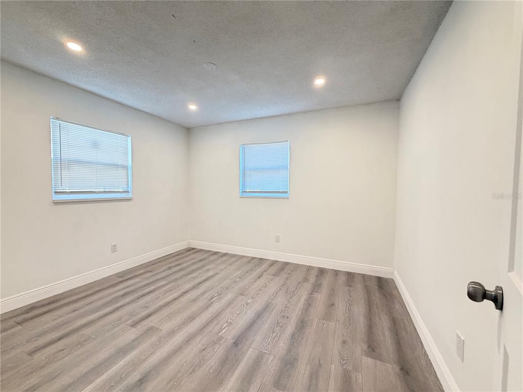 3207 Chariot Place Orlando, FL 32818 - Photo 16 of 21 wooden floor in a hall with a window