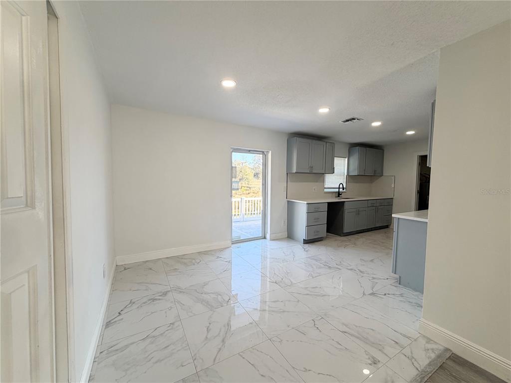 3207 Chariot Place Orlando, FL 32818 - Photo 5 of 21 a view of a kitchen with a sink and dishwasher oven window