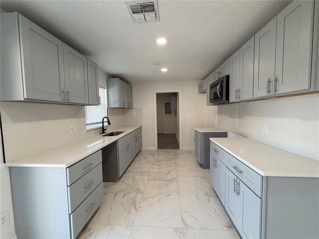 3207 Chariot Place Orlando, FL 32818 - Photo 7 of 21 a kitchen with a sink and cabinets