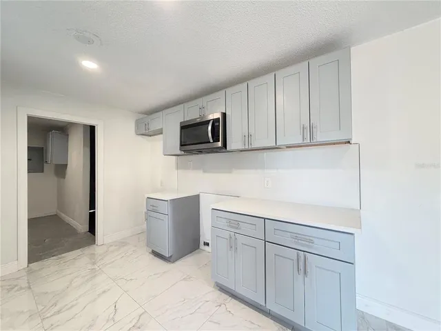 a kitchen with a sink and a microwave