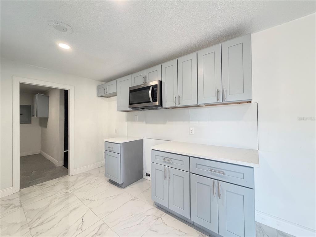 3207 Chariot Place Orlando, FL 32818 - Photo 8 of 21 a kitchen with a sink and a microwave
