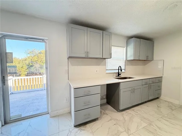 a kitchen with granite countertop cabinets and window