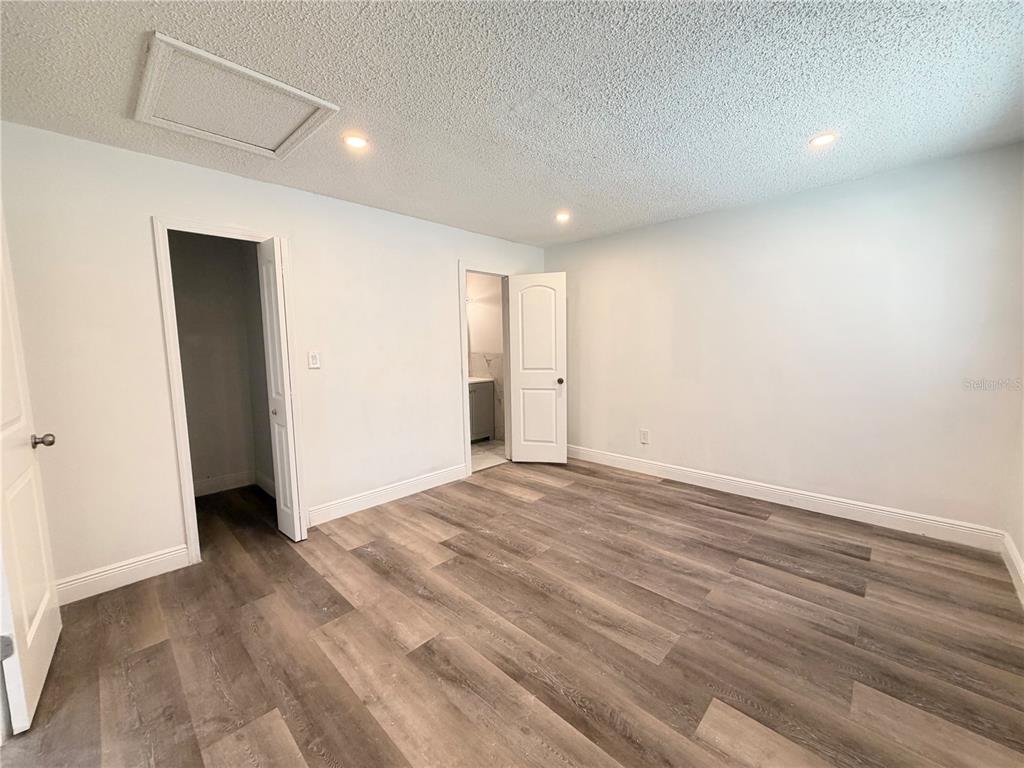 3207 Chariot Place Orlando, FL 32818 - Photo 10 of 21 a view of an empty room with wooden floor