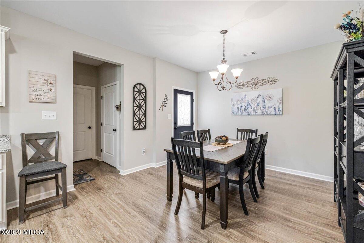249 Davis Road Gray, GA 31032 - Photo 11 of 53 a view of a dining room with furniture and wooden floor