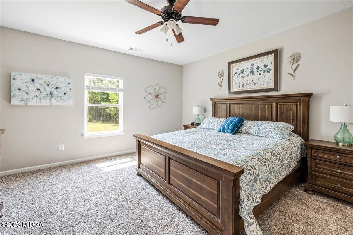 249 Davis Road Gray, GA 31032 - Photo 12 of 53 a bedroom with a bed and a window