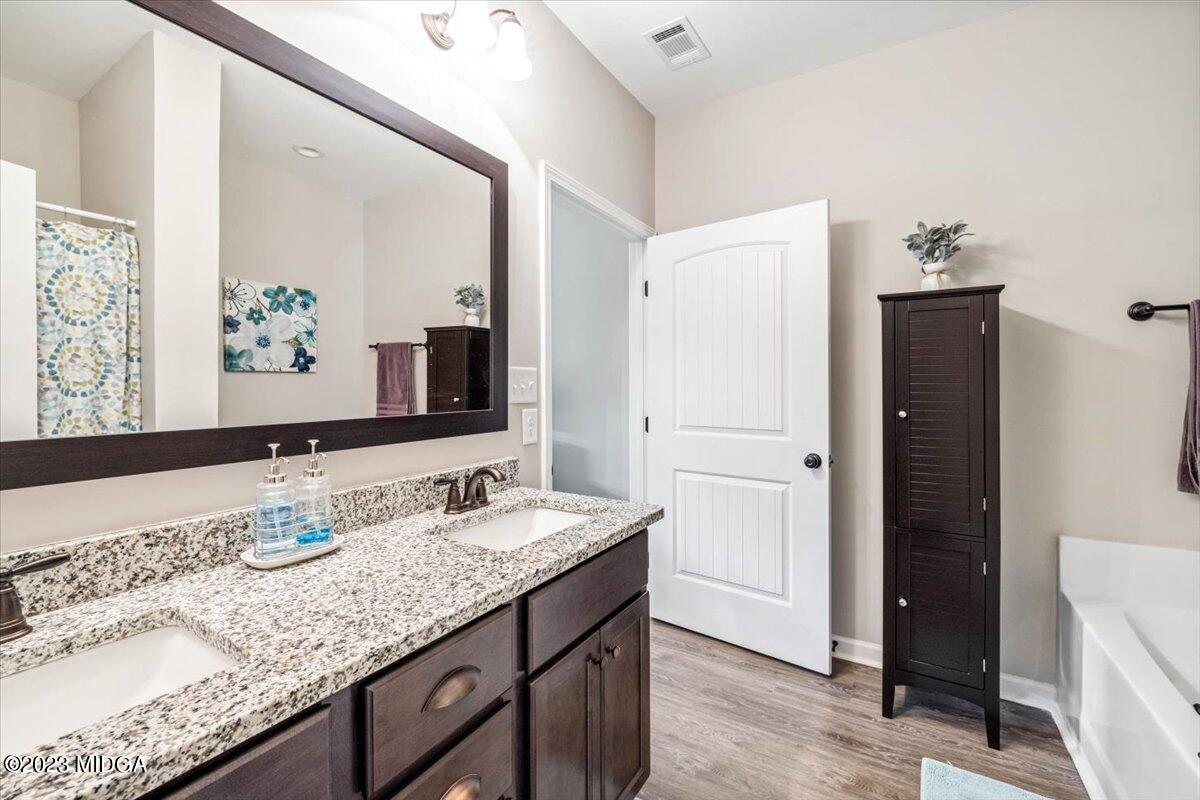 249 Davis Road Gray, GA 31032 - Photo 15 of 53 a bathroom with a granite countertop sink and a mirror