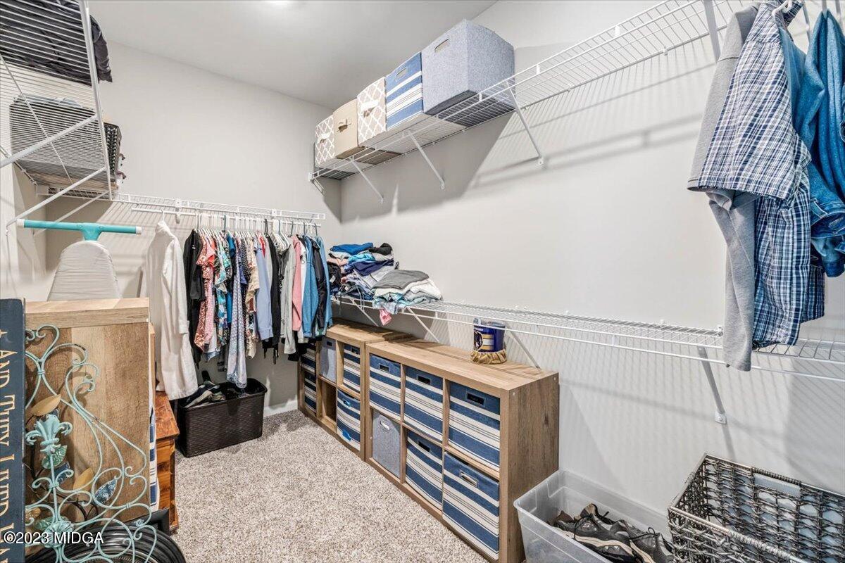 249 Davis Road Gray, GA 31032 - Photo 16 of 53 a view of walk in closet with clothes