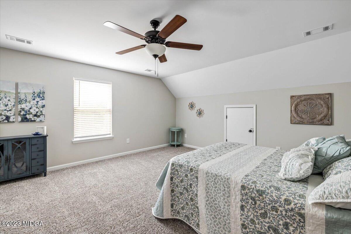 249 Davis Road Gray, GA 31032 - Photo 22 of 53 a bedroom with a large bed and a window