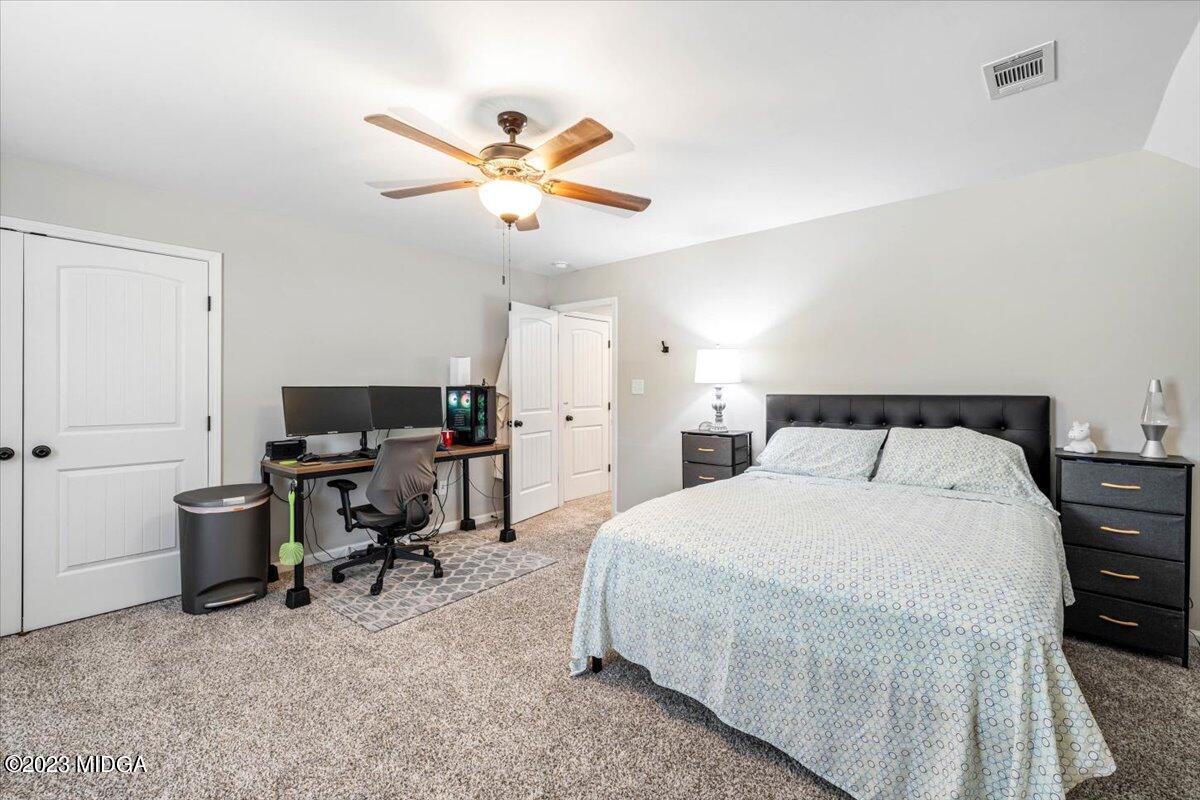 249 Davis Road Gray, GA 31032 - Photo 24 of 53 a bedroom with a bed and a chandelier