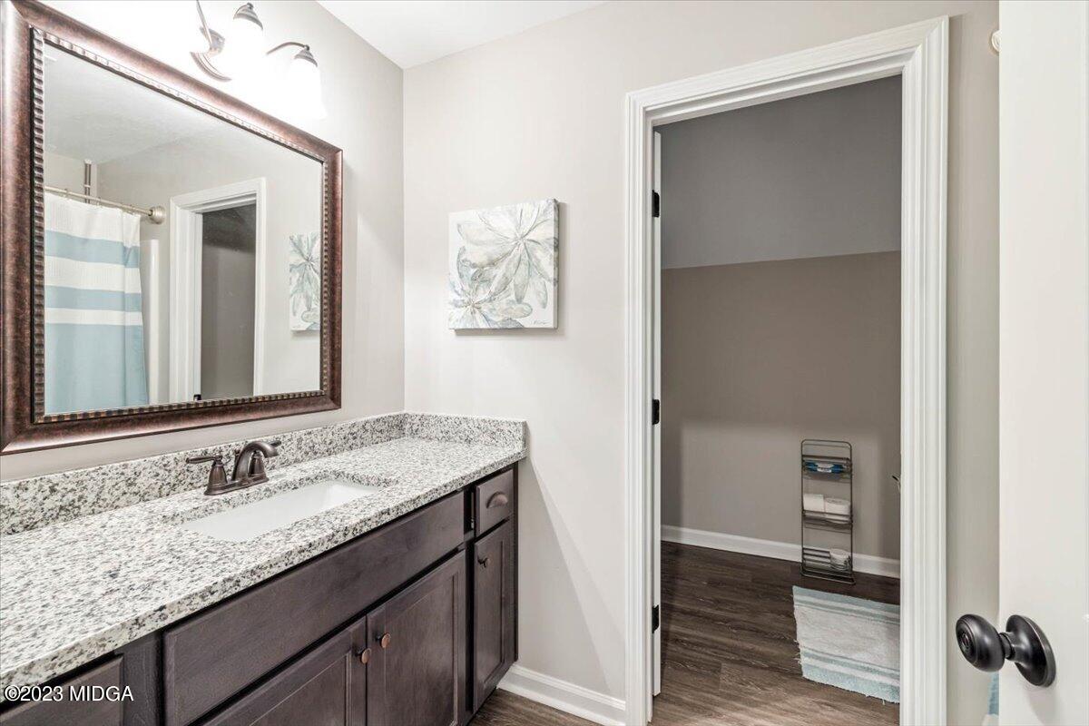 249 Davis Road Gray, GA 31032 - Photo 26 of 53 a bathroom with a granite countertop sink and a mirror