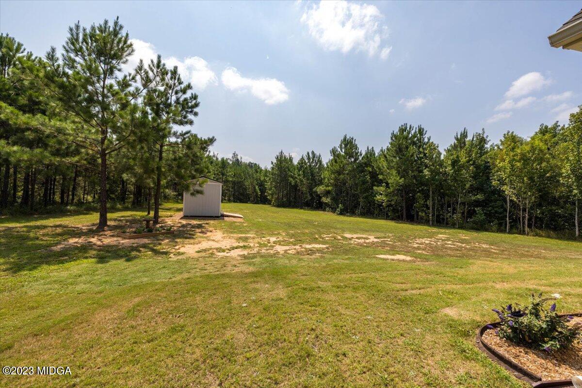 249 Davis Road Gray, GA 31032 - Photo 29 of 53 a view of a swimming pool with an outdoor space and seating area
