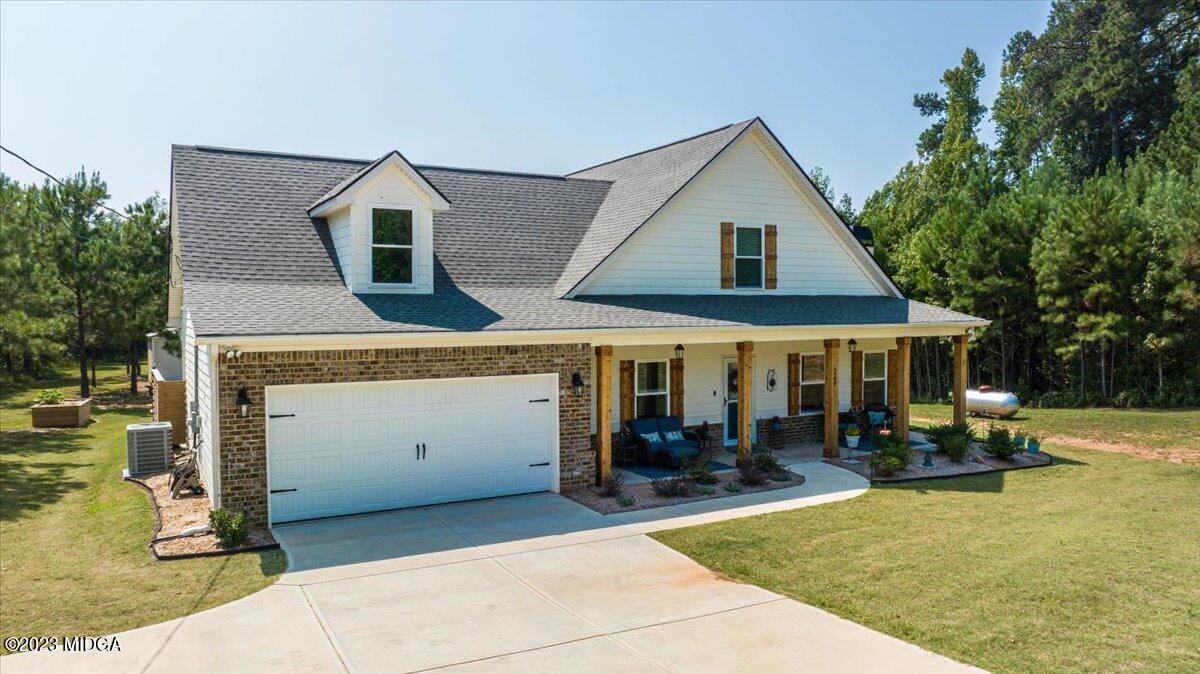249 Davis Road Gray, GA 31032 - Photo 52 of 53 a front view of a house with a garden and sitting area