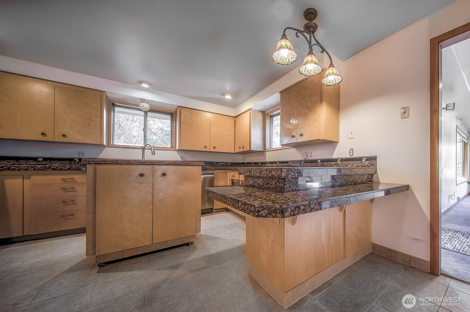 4110 Baker Ames Road Northeast Olympia, WA 98506 - Photo 23 of 40 a kitchen with stainless steel appliances granite countertop a sink and dishwasher a stove with wooden floor