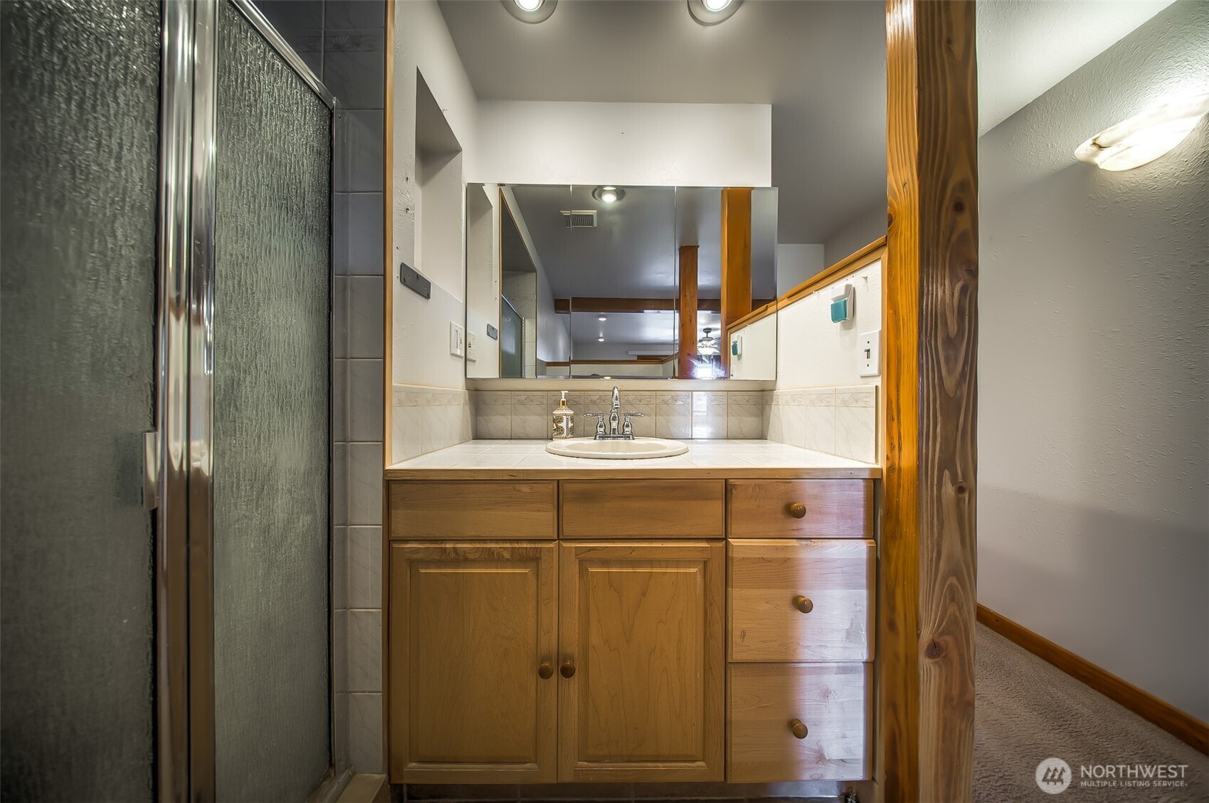 4110 Baker Ames Road Northeast Olympia, WA 98506 - Photo 28 of 40 a bathroom with a sink and a mirror