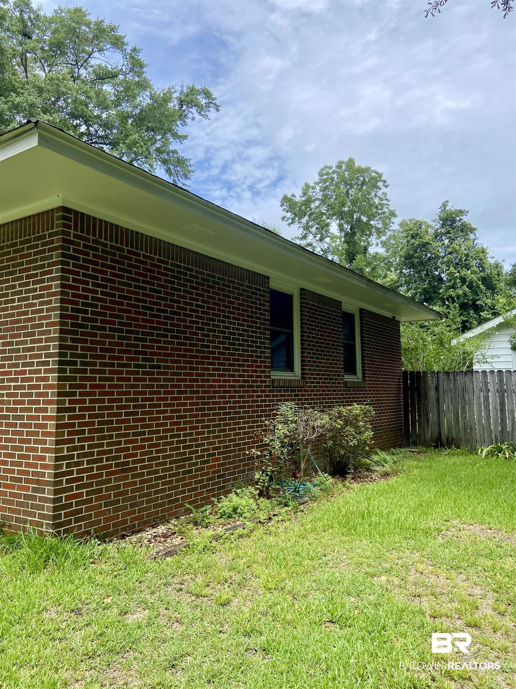 102 Ashley Street Evergreen, AL 36401 - Photo 24 of 26 View of property exterior with a lawn