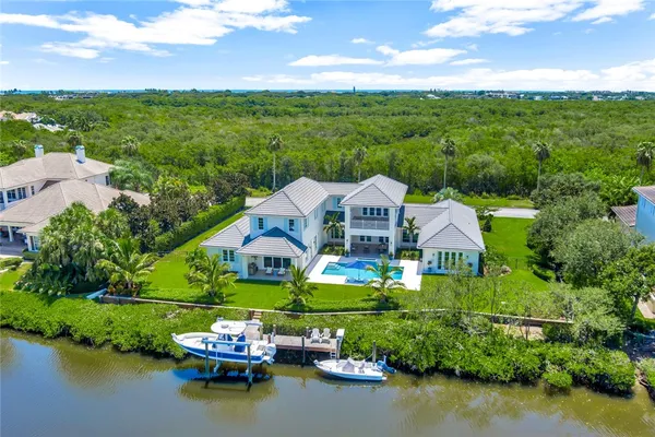 a aerial view of a house with pool lake view and mountain view